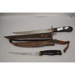 A vintage Normark knife in leather case and an Indian example in carved case with brass fitments