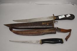 A vintage Normark knife in leather case and an Indian example in carved case with brass fitments