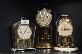 Three mid century mantel clocks with glass domes and floral details to faces.