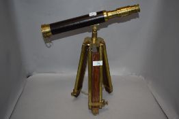 A modern telescope having mahogany and brass tripod, no makers mark.