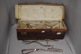 A collection of vintage medical apparatus including forceps.