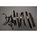 10 wrist watches all in black tones.