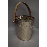 A hammered effect champagne bucket having leatherette handle.