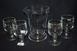 Four French glasses and a pitcher having dragon fly design.