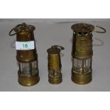 Three miniature replica brass Davy lamps.