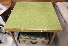 A vintage fold out card table and two vintage suitcases