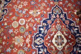 A traditional carpet square, red ground with blue foliate pattern, approx. 310 x 240cm