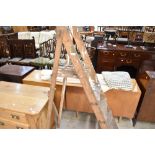 A set of vintage wooden decorators step ladders