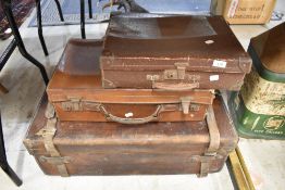 Three vintage leather bound suitcases