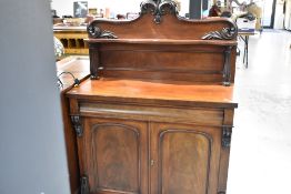 A Victorian mahogany chiffonier sideboard having shaped shelf ledge back , concealed drawer and