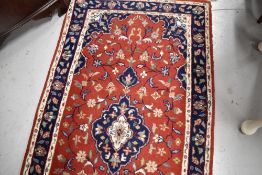 A traditional carpet runner, red ground with blue foliate pattern, approx. 304 x 77cm