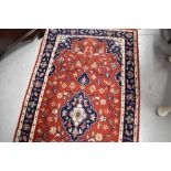 A traditional carpet runner, red ground with blue foliate pattern, approx. 304 x 77cm