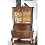 A fine early 20th Century mahogany display cabinet having broken pediment, blind fretwork frieze