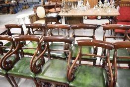 A set of ten William IV design mahogany scroll arm carver chairs, having leather seats and rail