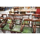 A set of ten William IV design mahogany scroll arm carver chairs, having leather seats and rail