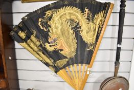 A vintage large sized Japanese fan hand painted with a dragon scene