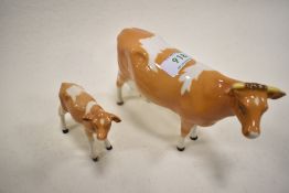 Two Beswick figure studies of a Guernsey Cow 2nd version 1248B and Calf 1249B