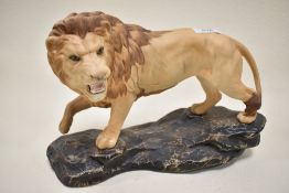 A Beswick figure of a lion on a rock 2554A