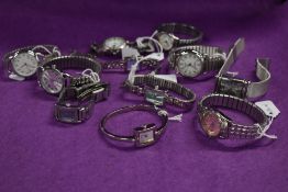 Ten ladies silver tone watches, some having coloured faces.