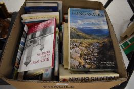 A carton of travel and walking themed books including Wainwright, Wordsworths Guide to the Hills,