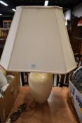 A ceramic table lamp with an octagonal shade.