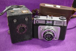 An Ilford Sportsman camera 1:2, 8/45mm Dacora lens and a Popular Brownie camera.