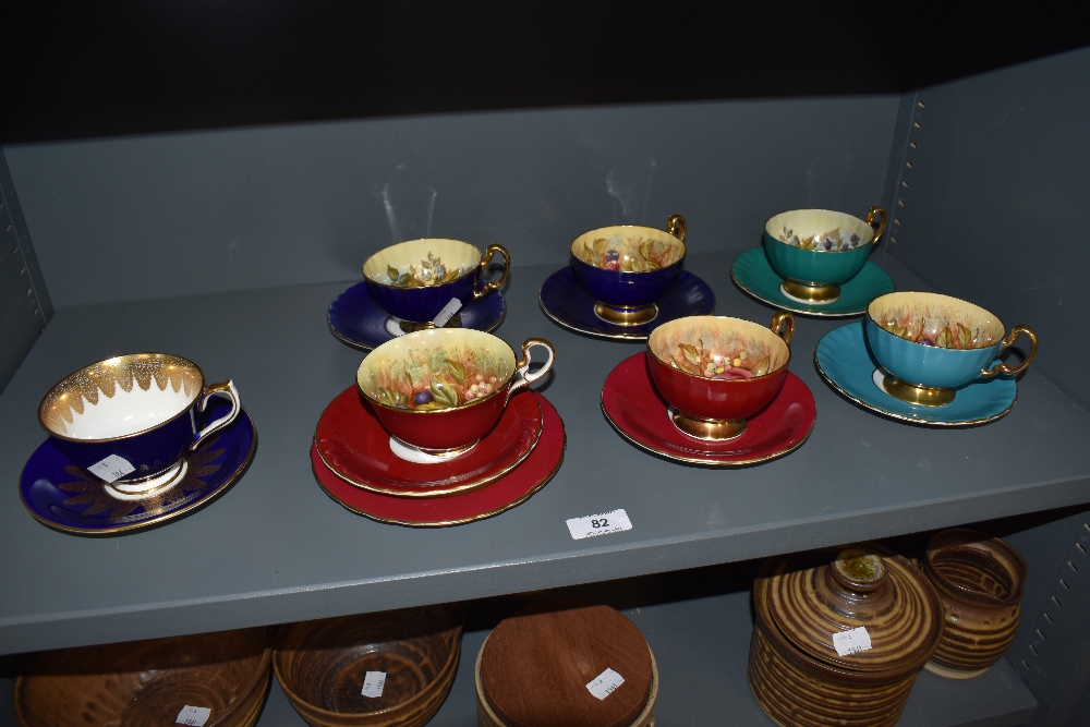 A group of Aynsley cabinet cups and saucers, gilt enriched with foliate decorated interiors, seven