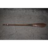 A Polynesian Oceanic art possibly Iron wood paddle having carved grip and tapered form, slight