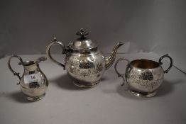 An early 20th century silver plated bachelor's tea set with embossed design and scroll worked