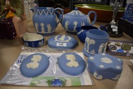 A selection of Wedgwood blue Jasper wares, teapot, jug, trinket box, plaques, each sprigged in the