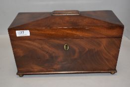 A Victorian tea caddy of casket form with fitted mahogany boxed interior, on brass ball feet with