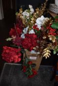 A quantity of festive artificial flowers and plants