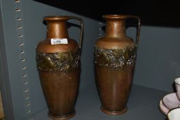 A pair of Arts and Crafts era Kaiser copper vases with brass effect ivy leaf decoration and handle