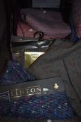 A box of Linton woven fabrics and tweeds