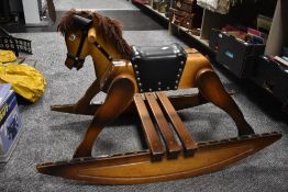 A Vintage wooden rocking horse, with studded leather saddle and rocking base