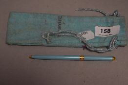 A small Tiffany & Co branded ball point pen, with draw-string bag