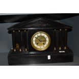 A Victorian Gothic slate mantel clock having Roman column supports with enamel dial reading J