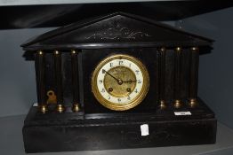 A Victorian Gothic slate mantel clock having Roman column supports with enamel dial reading J