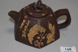 A Chinese Yixing or redware teapot, of hexagonal form, the circular cover with Foo dog finial over