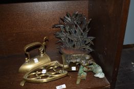 A cast-brass iron stand, with C-scroll decoration and twisted handle, sold together with a cast