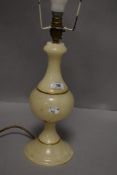 A turned alabaster table lamp, with gilt embellishments, lacking shade
