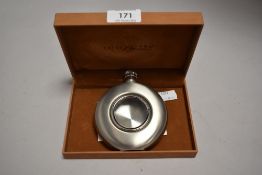 An Aston Brown (london) stainless steel 4.5OZ hipflask, with glazed central circular aperture,