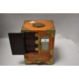 A modern miniature oriental jewellery chest having inlaid jade stone carved panels and brass