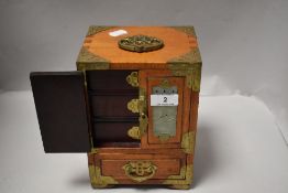 A modern miniature oriental jewellery chest having inlaid jade stone carved panels and brass