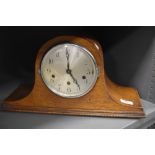 An Edwardian mantel clock having oak case in a Napoleon design AF