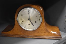 An Edwardian mantel clock having oak case in a Napoleon design AF