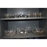 Two shelves of various cut and pressed glass items including sundae dishes, bowls and cocktail