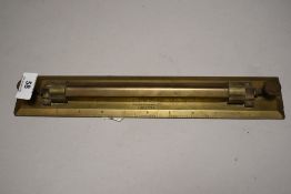 An early 20th century C Smith Clerkenwell brass map navigation rule bearing a military arrow.