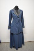 An Edwardian two piece ladies suit, comprising of jacket and skirt in teal blue having brocade
