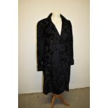 A 1930s black coat having frog fastenings and turn up's to cuffs.